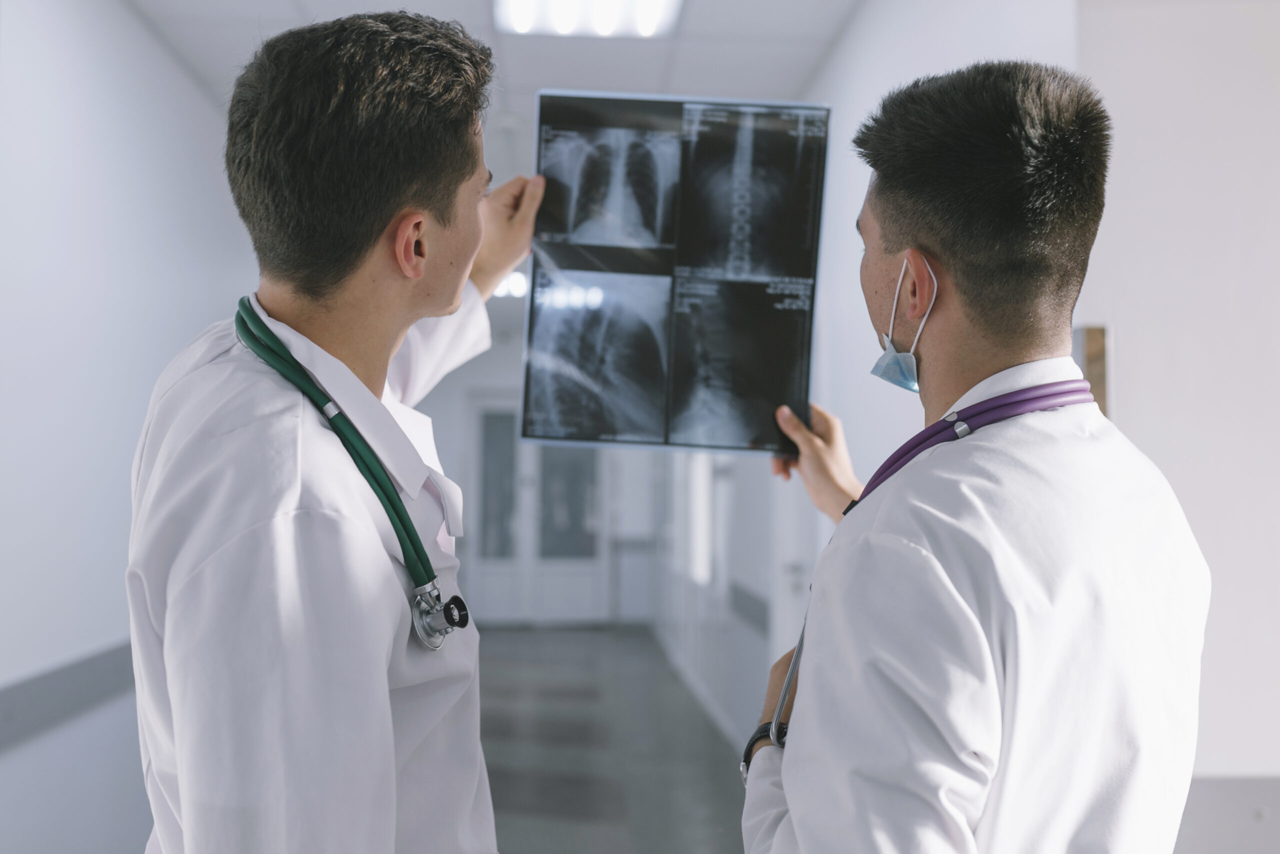 two-male-doctors-looking-x-ray